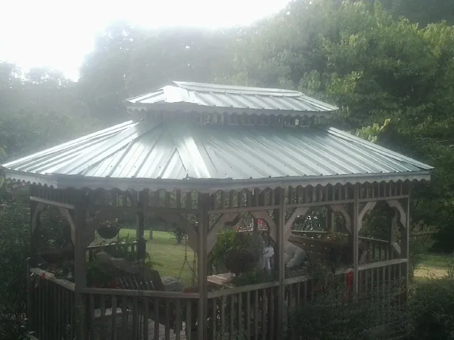 Two tier green metal roof on a garden gazebo in Litchfield Park
